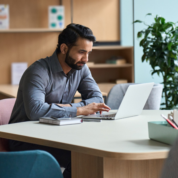 Man at computer using apprenticeship wage schedule software