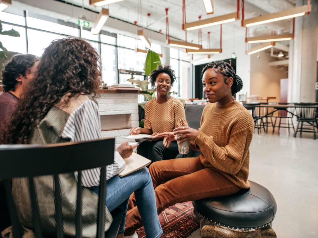 2 A group of interns chatting in a lounge area.