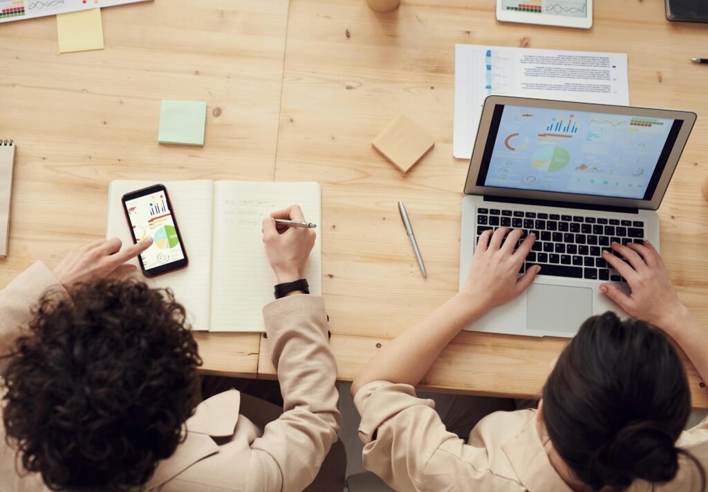 Two people accessing the same shared data on two different devices.