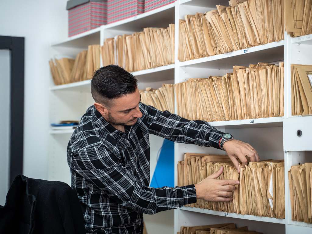 fresh graduate black american woman A man sorting through reams of old paperwork.