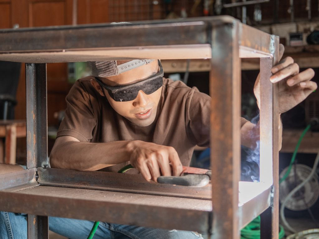Skill Mastery and Certification A young welding apprentice hard at work.