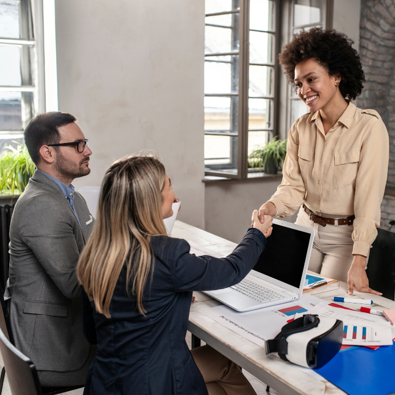 An apprentice shaking hands with her mentor during onboarding