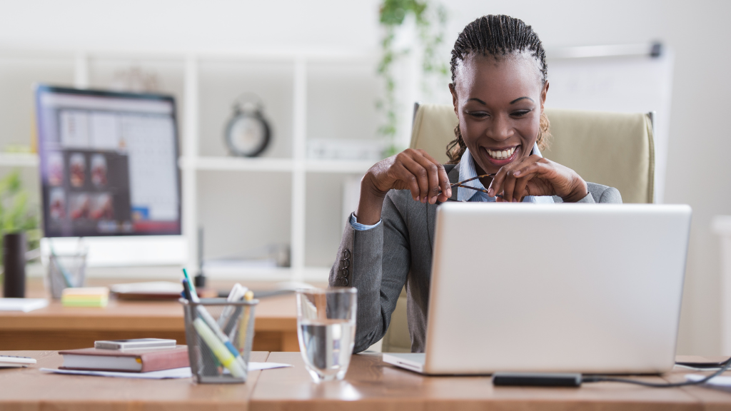 Happy woman in front of laptop
