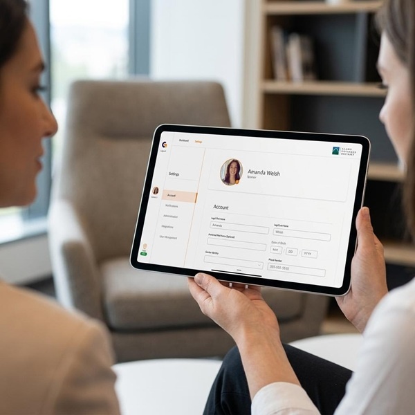 Two women viewing GoSprout's apprenticeship software on a tablet device.